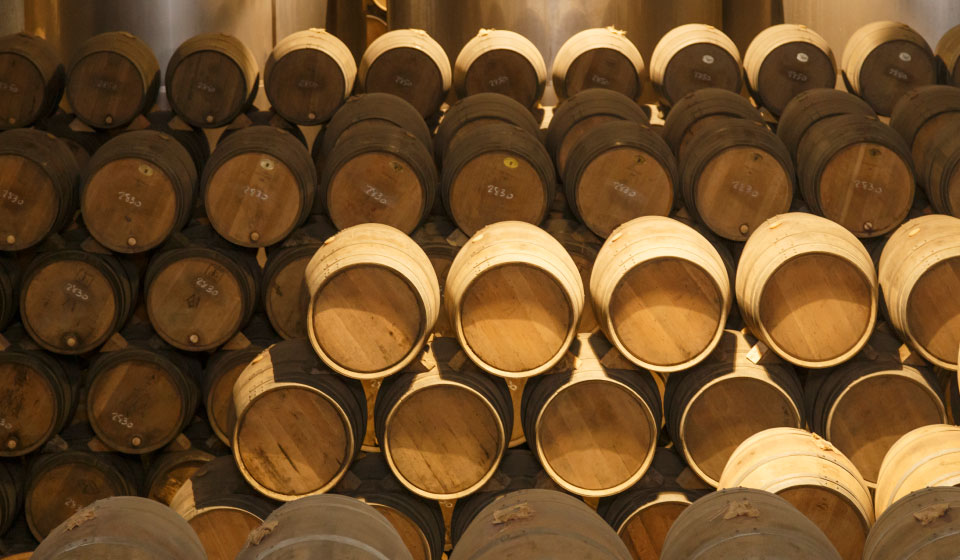 whisky casks stacked in warehouse rows