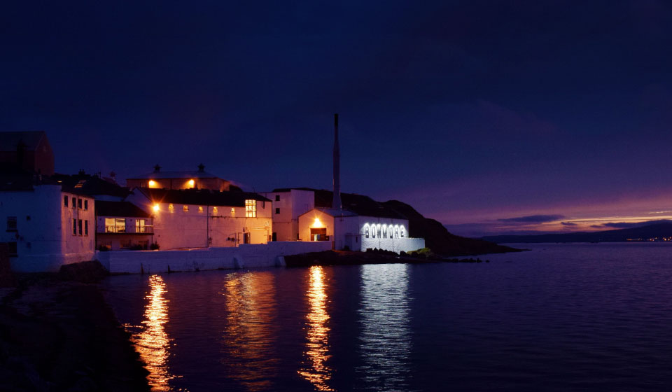 Islay coastline with distillery buildings showing maritime whisky environment